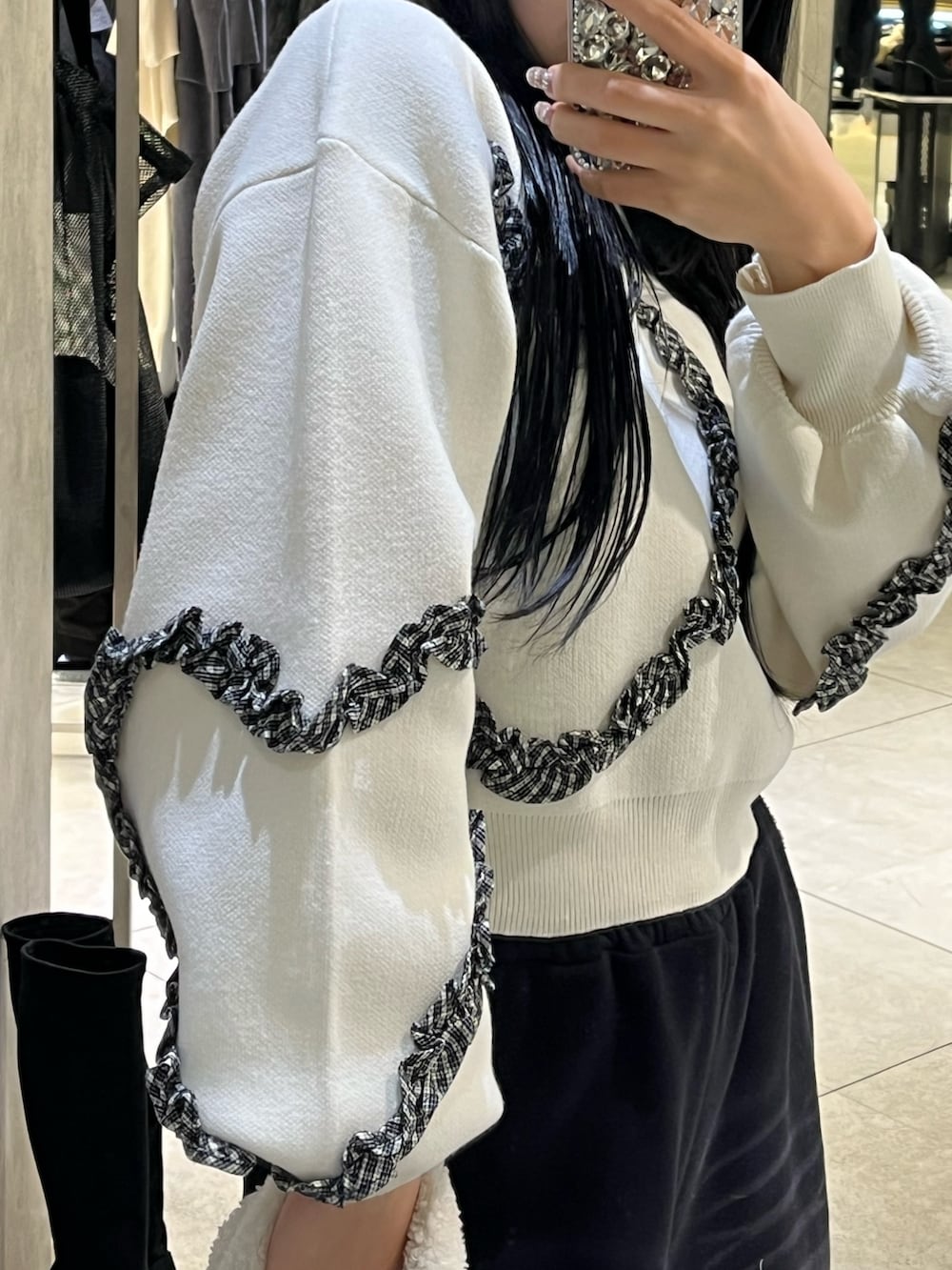 ホワイト系のニット/セーター、ブラック系のスウェットパンツ、ブラック系のハンドバッグを着用したレディースの冬コーディネートの6枚目の写真