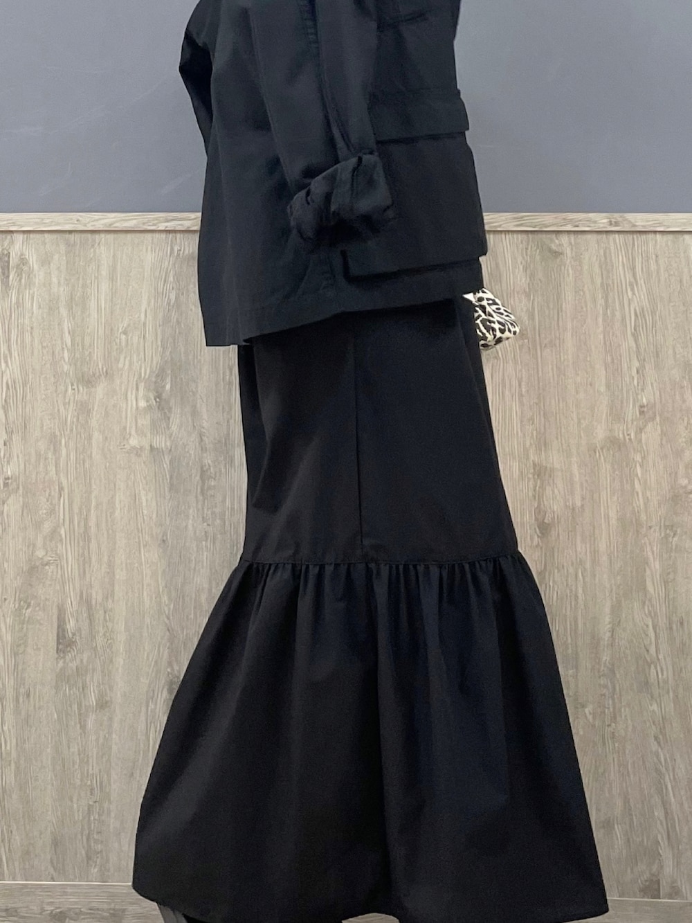 ブラック系のスカート、グレー系のショルダーバッグ、ホワイト系のTシャツ/カットソーを着用したレディースの春コーディネートの4枚目の写真