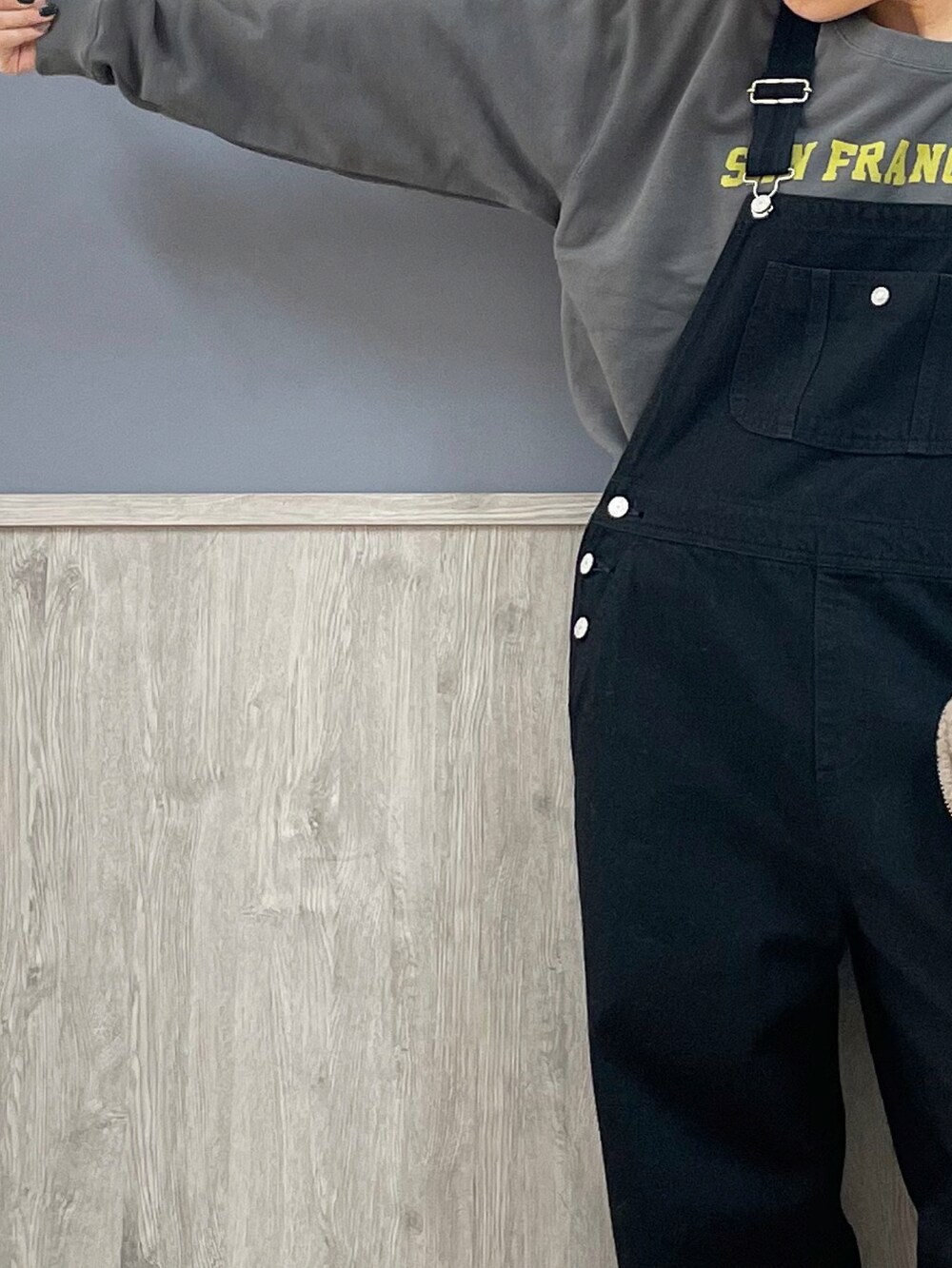 ブラック系のサロペット/オーバーオール、グレー系のスウェット、グレー系のその他アウターを着用したレディースの冬コーディネートの2枚目の写真