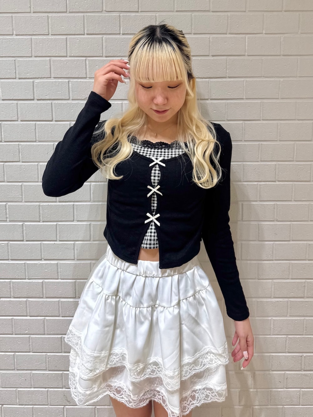 ホワイト系のスカート、ブラック系のTシャツ/カットソーを着用したレディースの冬コーディネートの3枚目の写真