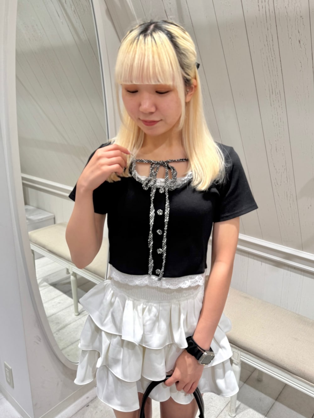 ブラック系のTシャツ/カットソー、ホワイト系のスカート、ブラック系のショルダーバッグを着用したレディースの夏コーディネートの3枚目の写真