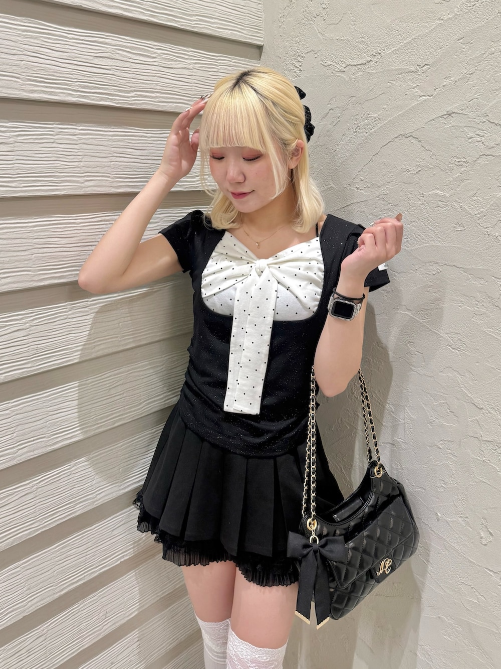 ブラック系のTシャツ/カットソー、ブラック系のショルダーバッグ、ブラック系のパンプスを着用したレディースの春コーディネートの4枚目の写真