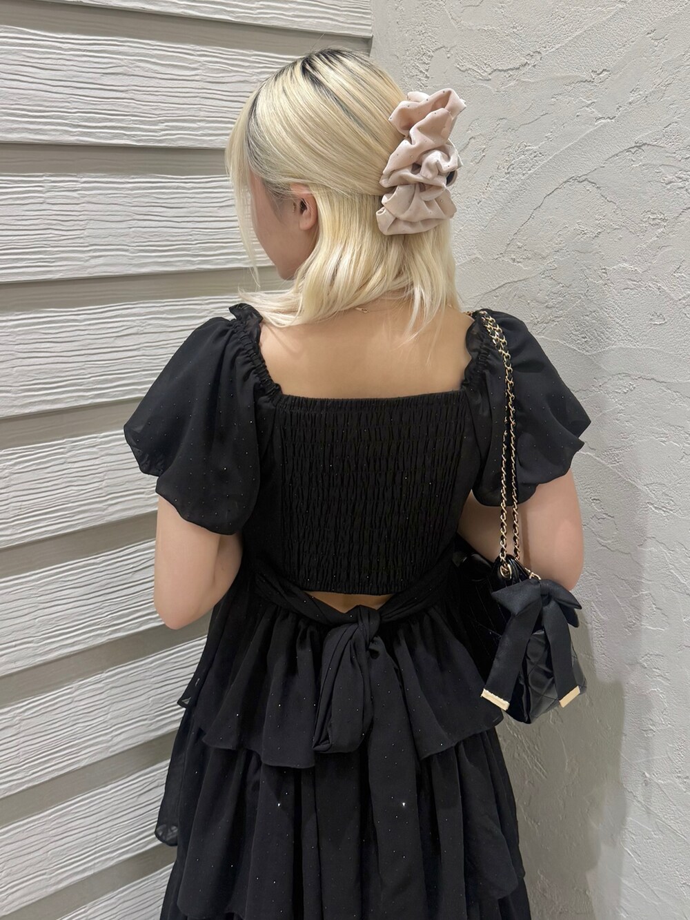 ブラック系のワンピース、ブラック系のショルダーバッグ、ブラック系のパンプスを着用したレディースの春コーディネートの7枚目の写真