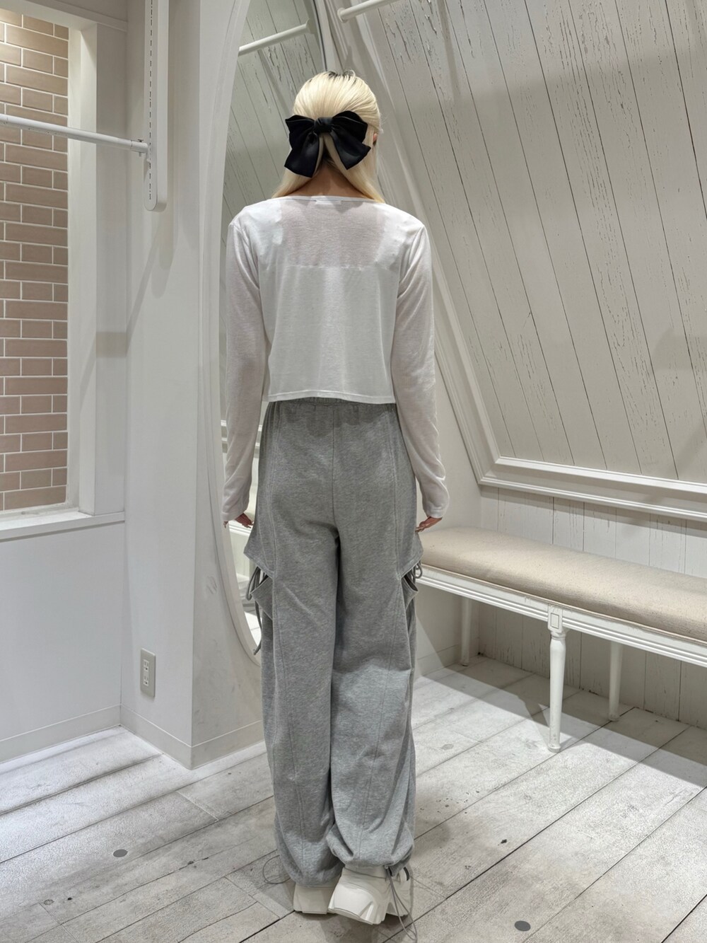 ホワイト系のカーディガン/ボレロ、ホワイト系のスニーカー、グレー系のスウェットパンツを着用したレディースの夏コーディネートの3枚目の写真