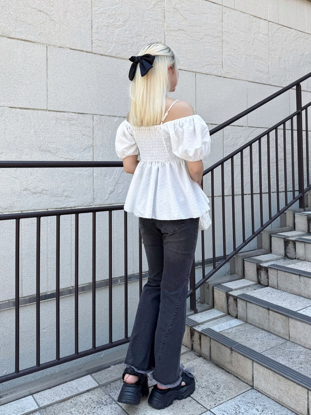 ホワイト系のシャツ/ブラウス、ブラック系のデニムパンツ、ホワイト系のボストンバッグを着用したレディースの夏コーディネートの2枚目の写真