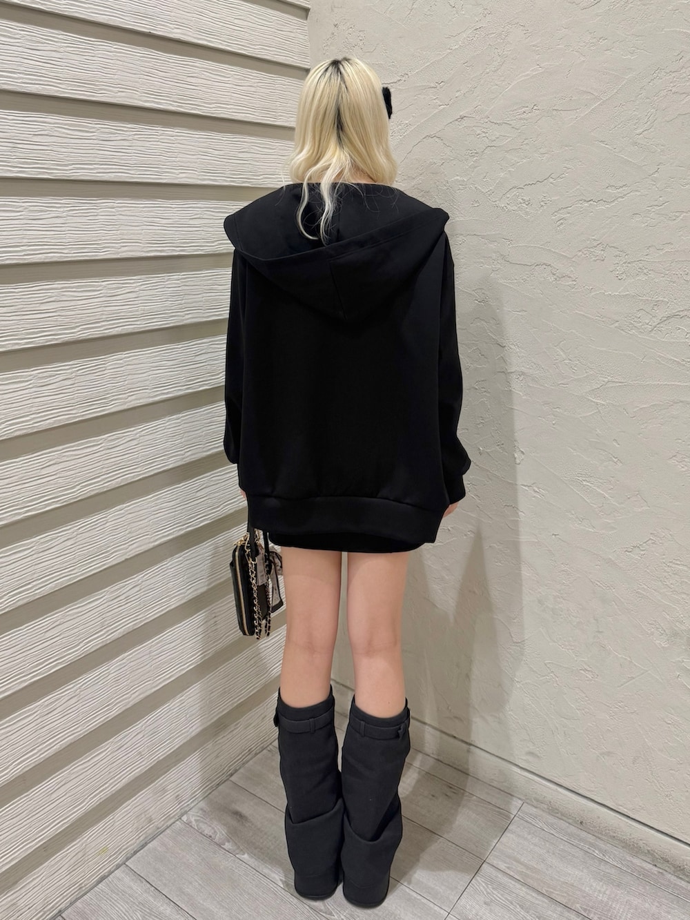 ブラック系のワンピース、ブラック系のパーカー、ブラック系のショルダーバッグを着用したレディースの冬コーディネートの3枚目の写真