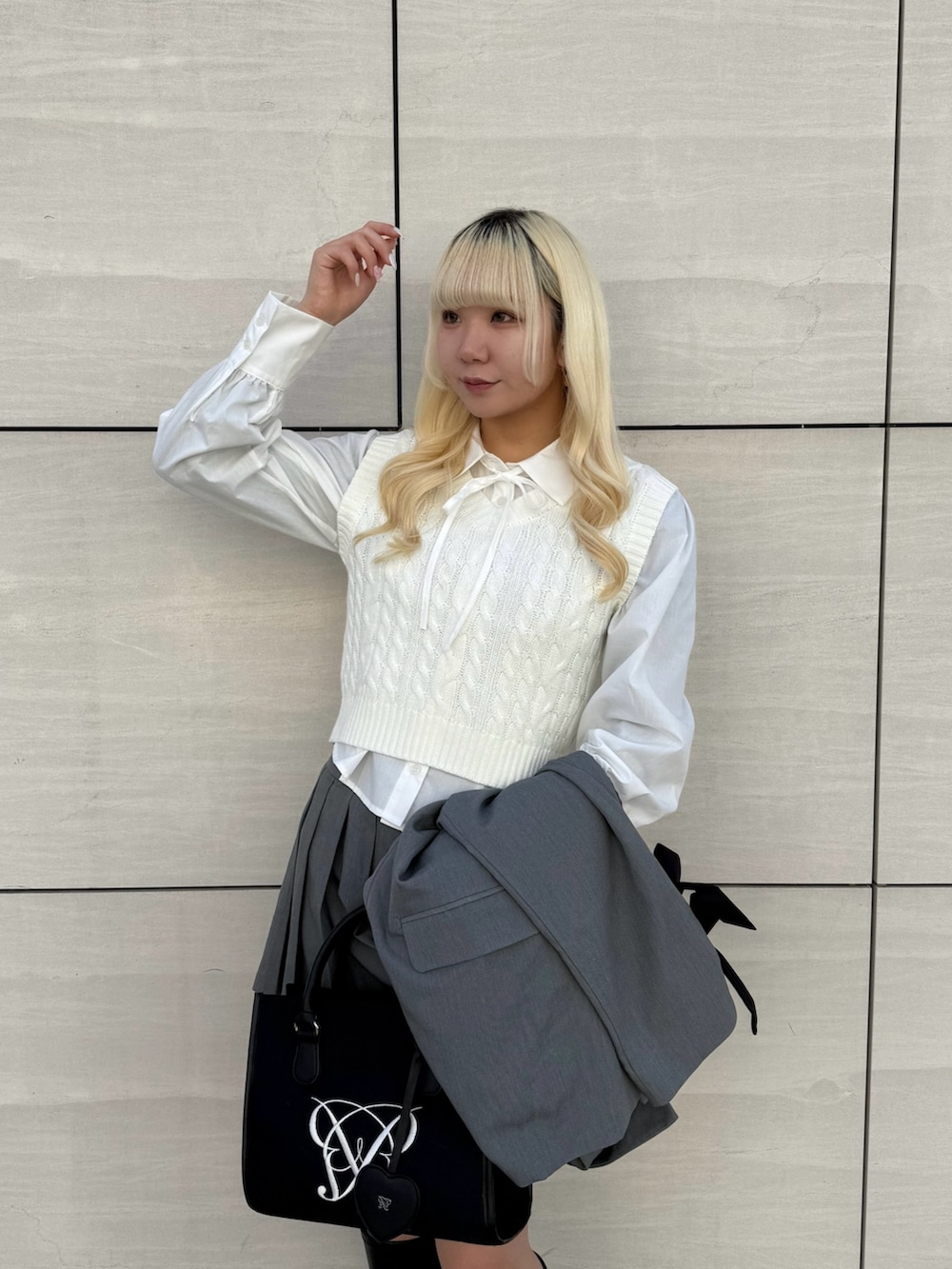 ブラック系のトートバッグ、ホワイト系のシャツ/ブラウス、グレー系のその他アウターを着用したレディースの春コーディネートの4枚目の写真