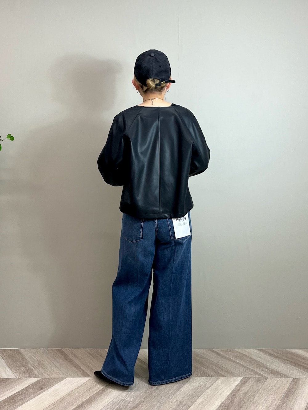 ブラック系のその他アウター、ブラック系のTシャツ/カットソー、ブルー系のデニムパンツを着用したレディースの秋コーディネートの3枚目の写真