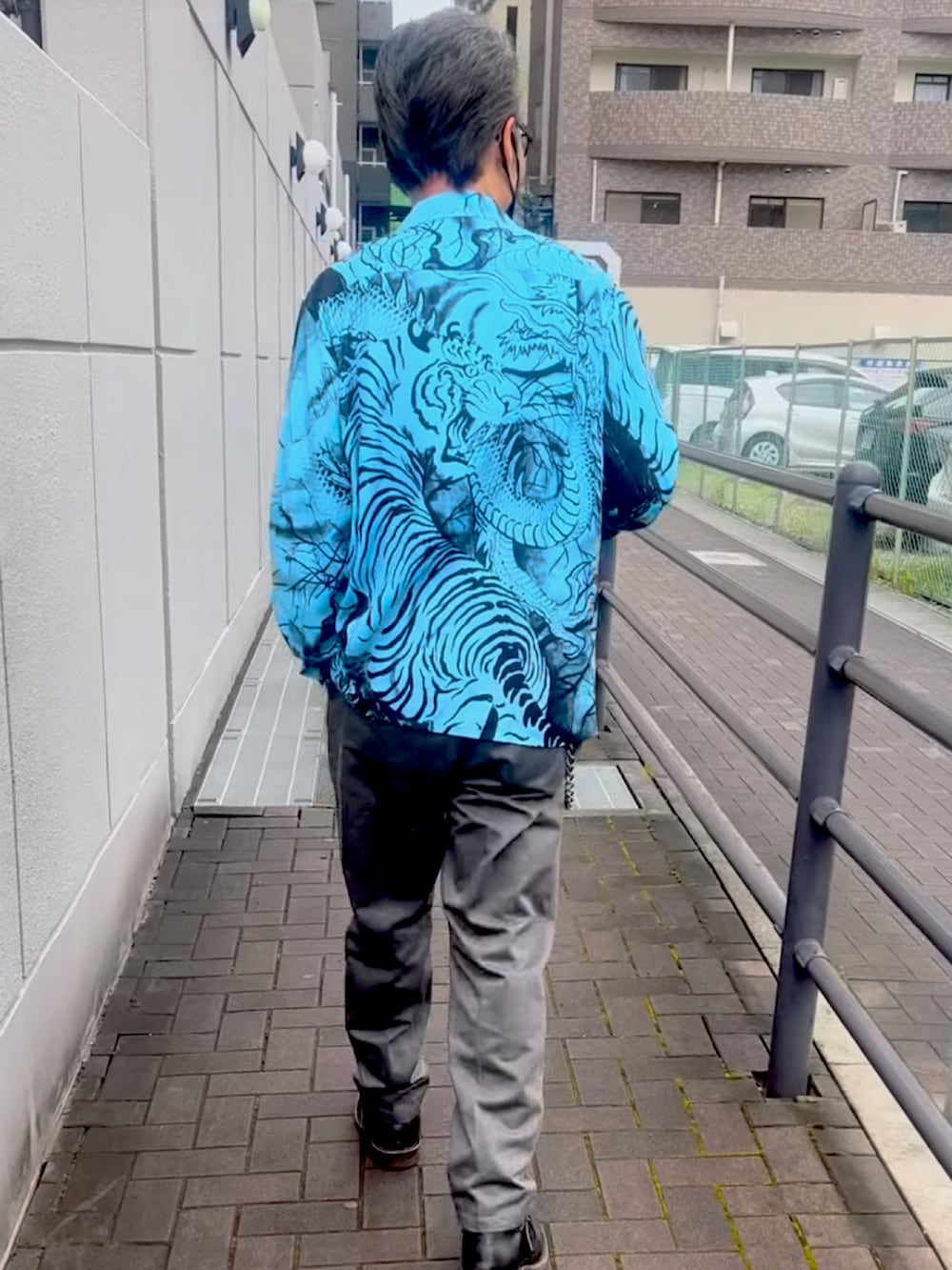 ベージュ系のシャツ/ブラウス、グレー系のチノパンツ、ブラック系のブーツを着用したメンズの夏コーディネートの2枚目の写真