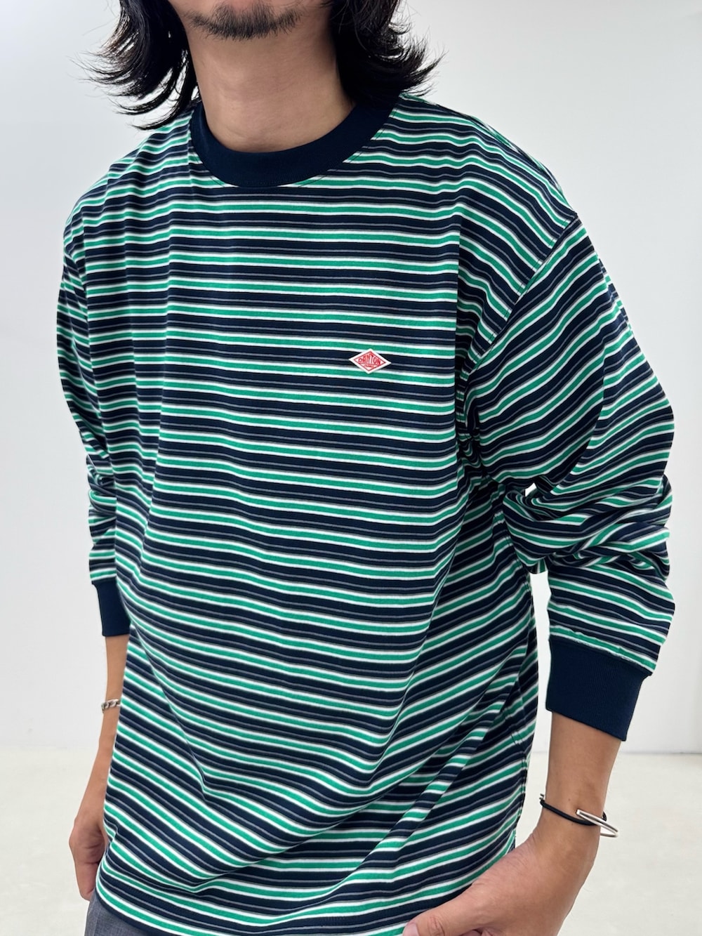 ブルー系のTシャツ/カットソー、グレー系のスラックスを着用したメンズの秋コーディネートの4枚目の写真