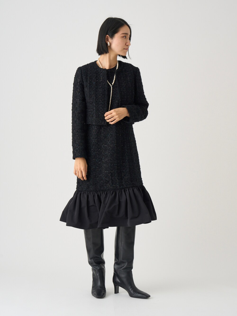 ブラック系のワンピース、ホワイト系のネックレスを着用したレディースの秋コーディネートの5枚目の写真