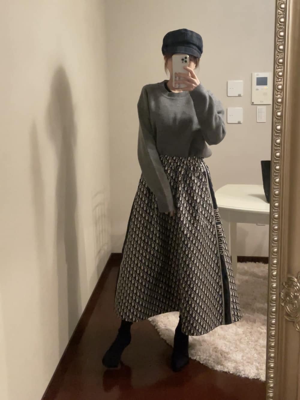 グレー系のスカート、グレー系のトップス、グレー系のシューズを着用したレディースの冬コーディネートの2枚目の写真