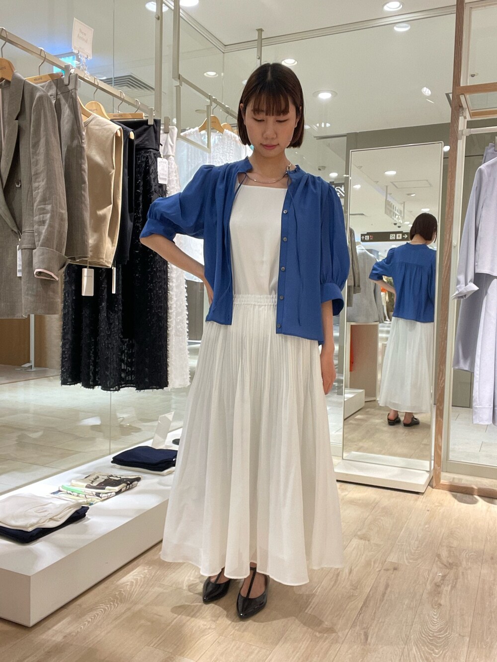 ブルー系のシャツ/ブラウス、ホワイト系のタンクトップ、ホワイト系のスカートを着用したレディースの夏コーディネートの2枚目の写真