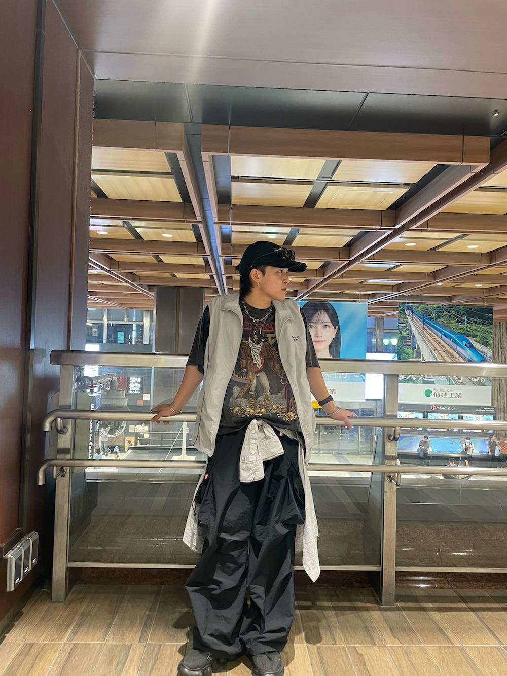 ブラック系のカーゴパンツ、ブラック系のTシャツ/カットソー、グレー系のナイロンジャケットを着用したメンズの秋コーディネートの2枚目の写真