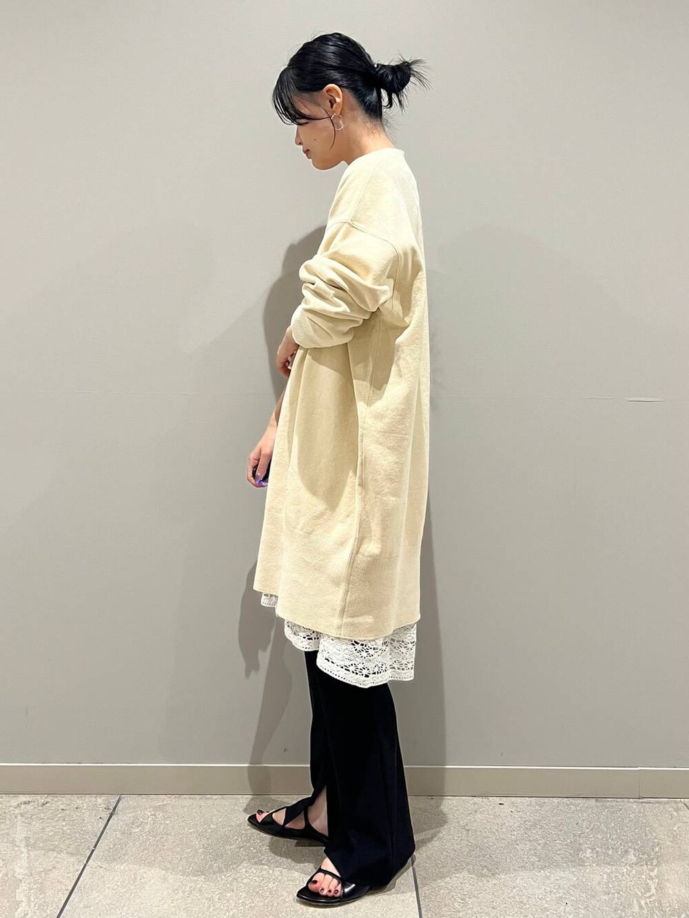 ブラック系のその他パンツ、ホワイト系のニット/セーター、イエロー系のボディバッグ/ウエストポーチを着用したレディースの夏コーディネートの3枚目の写真