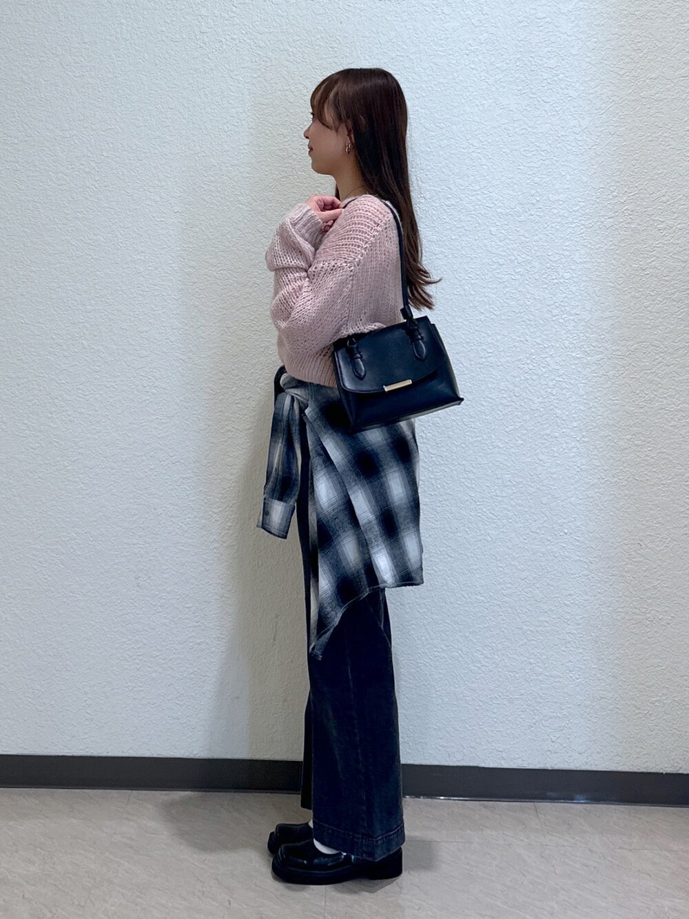 ブラック系のデニムパンツ、ブラック系のシャツ/ブラウス、ブラック系のパンプスを着用したレディースの秋コーディネートの3枚目の写真