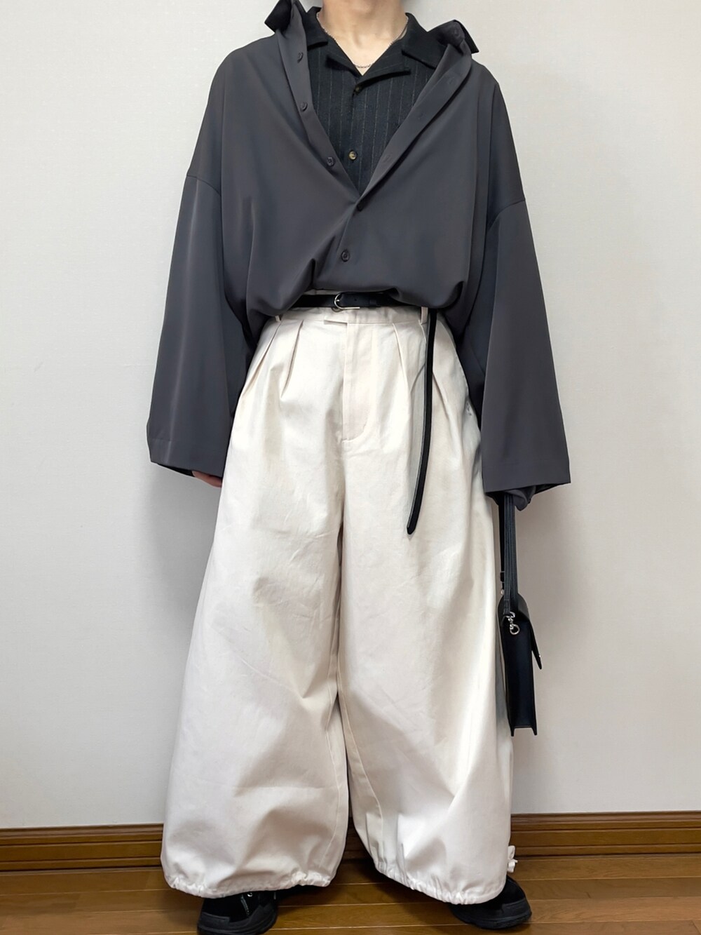 グレー系のシャツ/ブラウス、ブラック系のショルダーバッグ、ブラック系のスニーカーを着用したメンズの春コーディネートの3枚目の写真