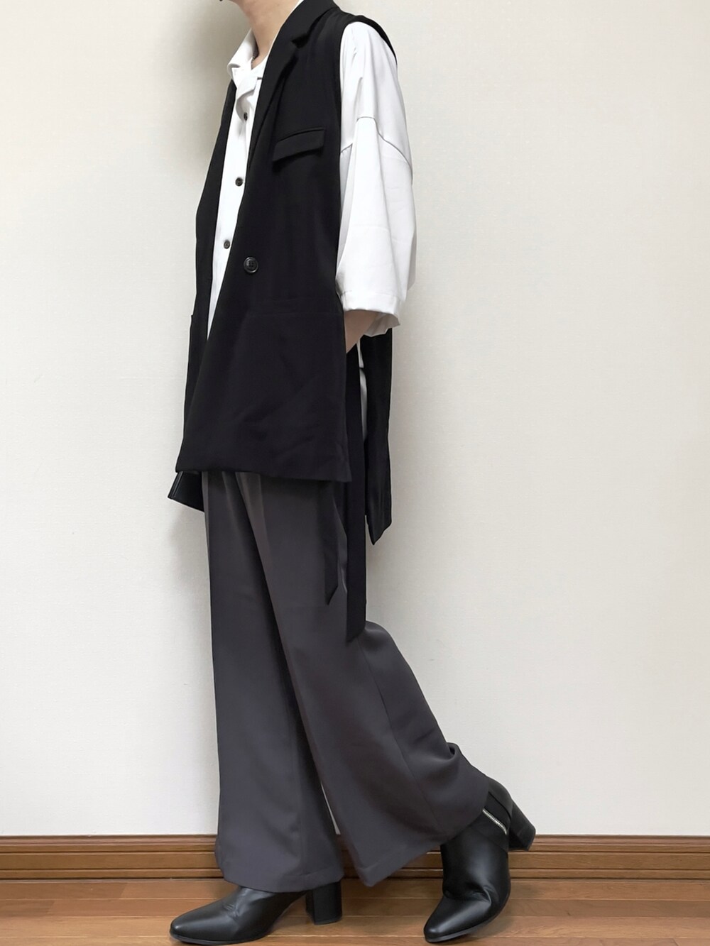 グレー系のスラックス、ブラック系のブーツ、ブラック系のショルダーバッグを着用したメンズの夏コーディネートの2枚目の写真