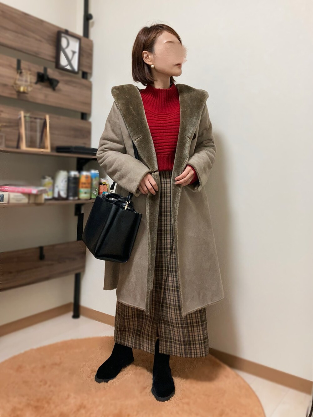 レッド系のニット/セーター、ベージュ系のスカート、パープル系のトートバッグを着用したレディースの冬コーディネートの3枚目の写真