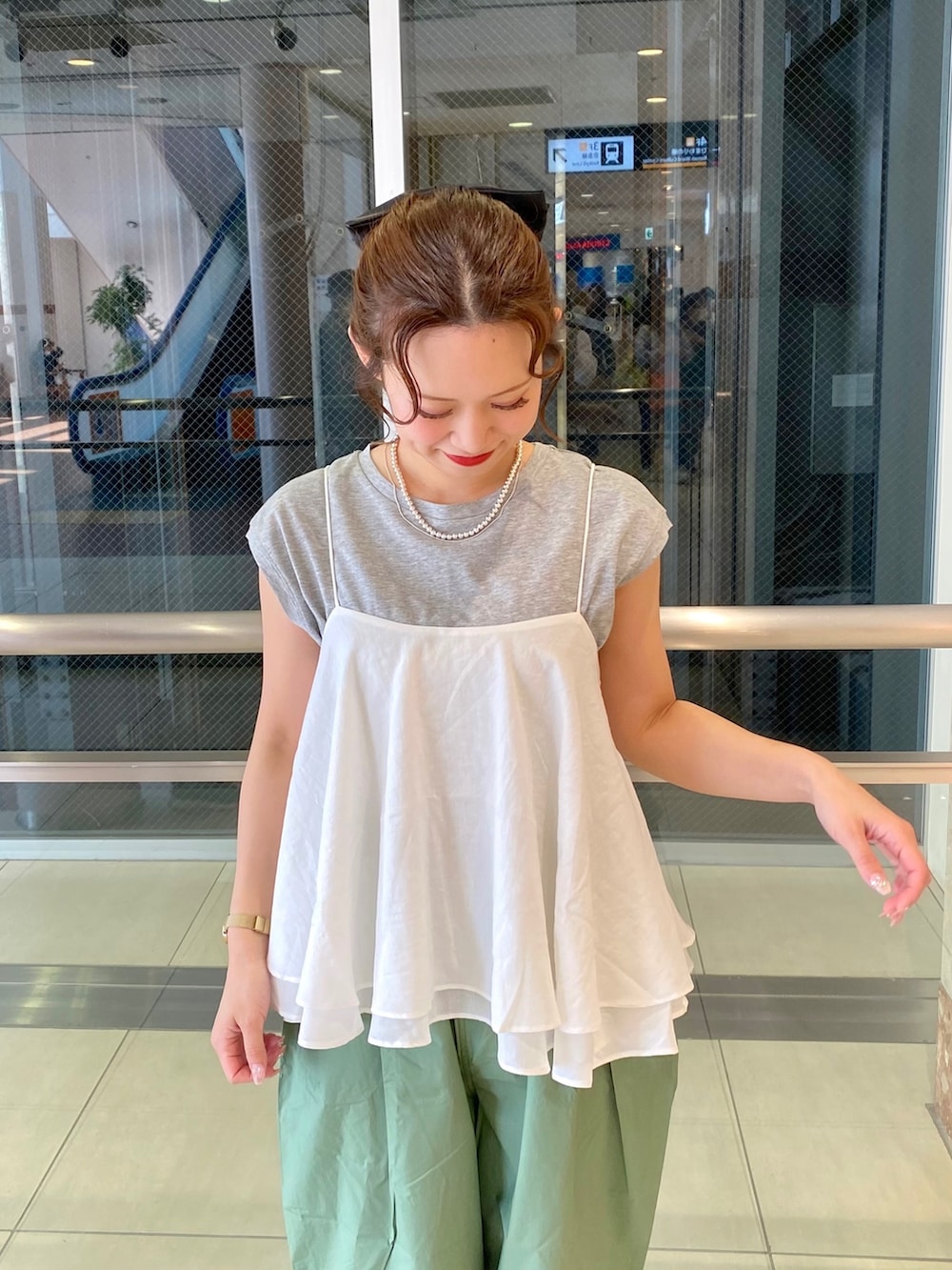 ホワイト系のキャミソール、グリーン系のパンツ、グレー系のTシャツ/カットソーを着用したレディースの春コーディネートの3枚目の写真