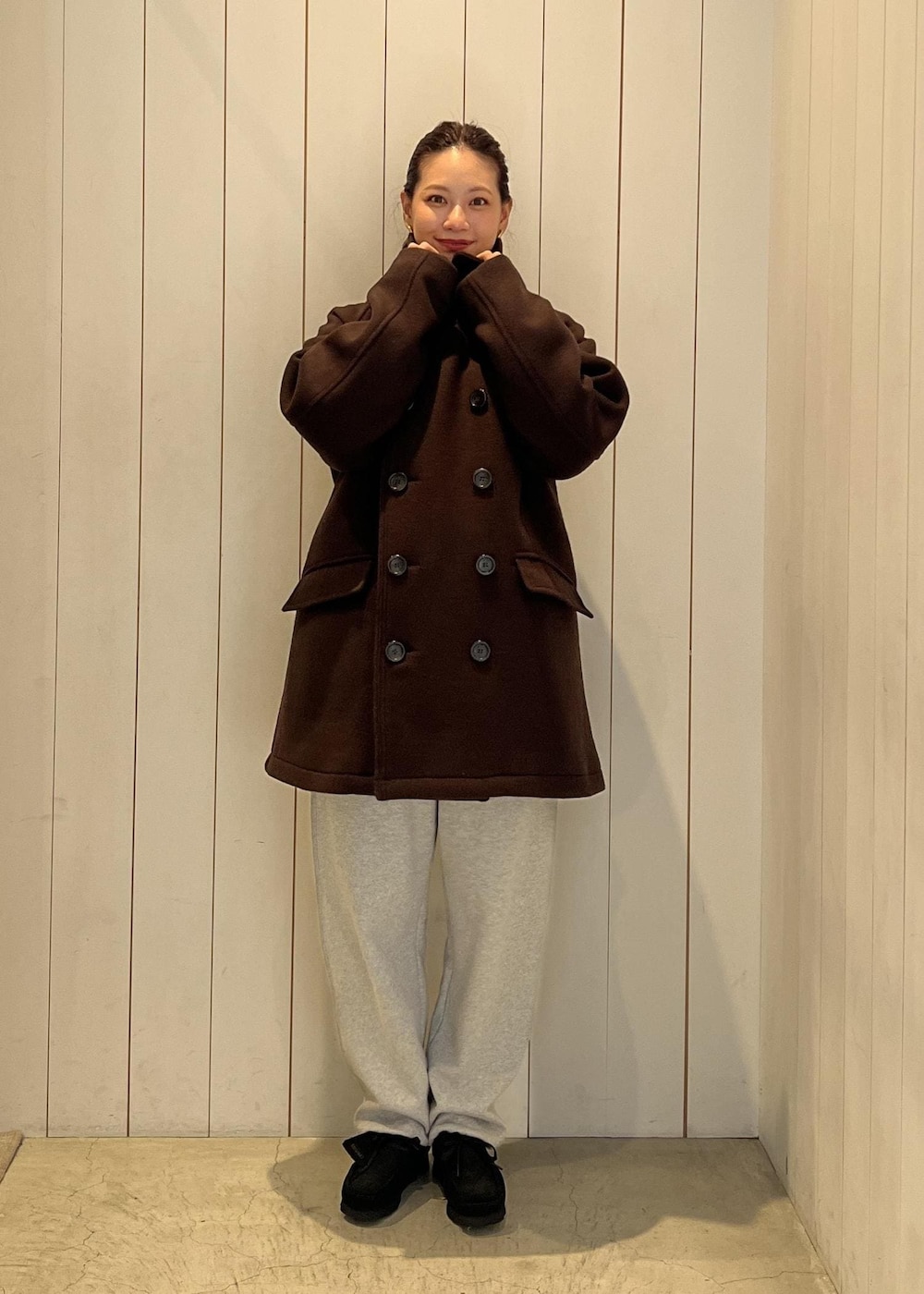 グレー系のその他パンツ、ブラウン系のピーコートを着用したレディースの秋コーディネートの2枚目の写真