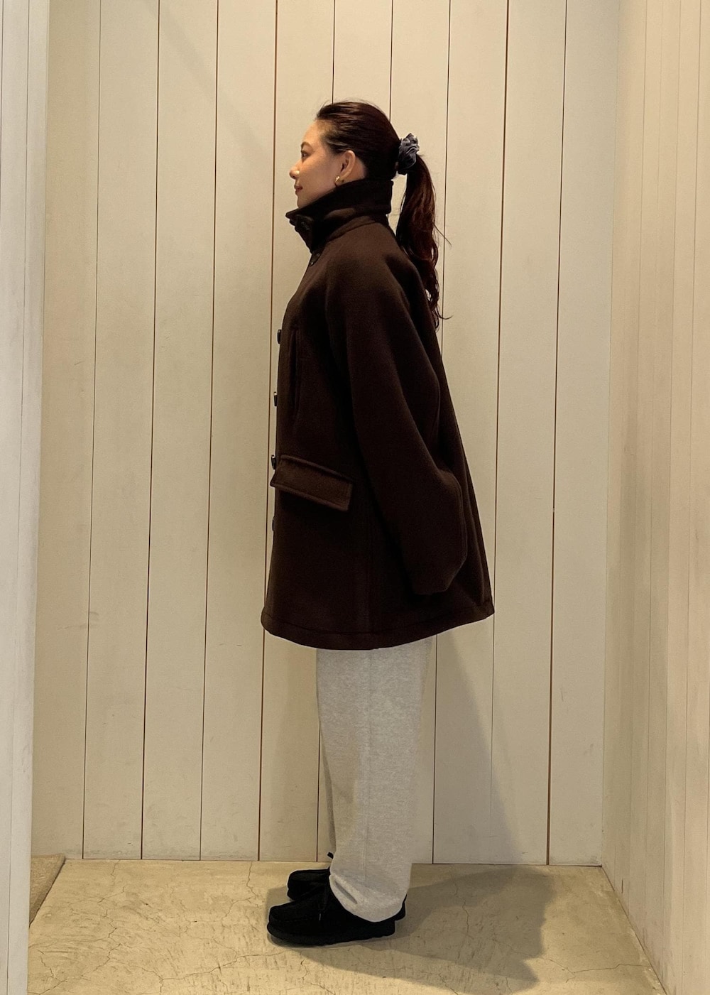 グレー系のその他パンツ、ブラウン系のピーコートを着用したレディースの秋コーディネートの3枚目の写真