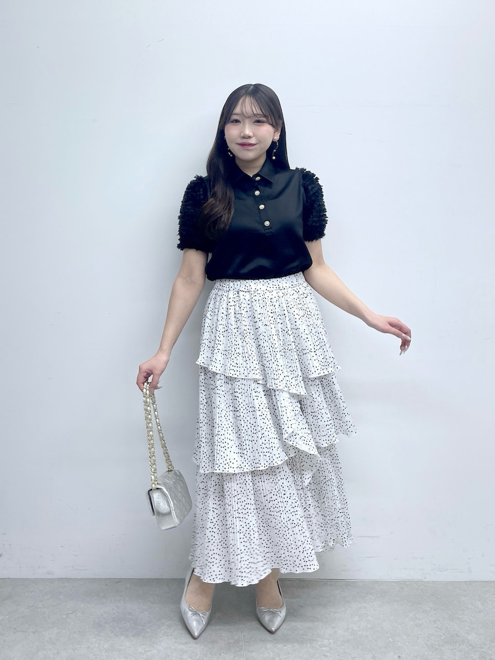 ブラック系のシャツ/ブラウス、ホワイト系のスカートを着用したレディースの春コーディネートの2枚目の写真