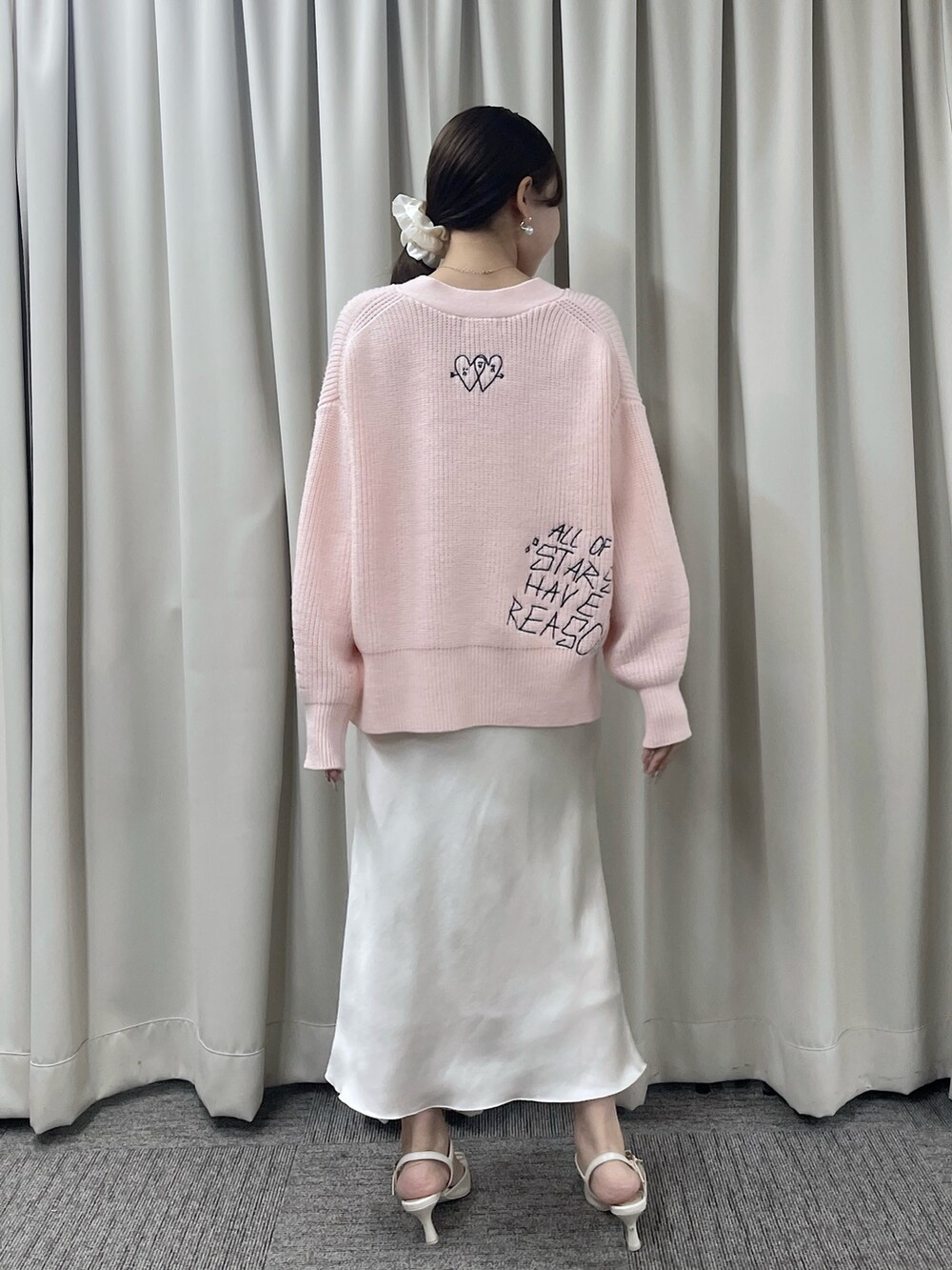 ピンク系のカーディガン/ボレロ、ホワイト系のスカートを着用したレディースの秋コーディネートの5枚目の写真