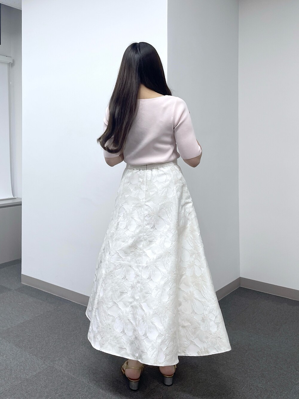 ピンク系のニット/セーター、ホワイト系のスカートを着用したレディースの春コーディネートの4枚目の写真