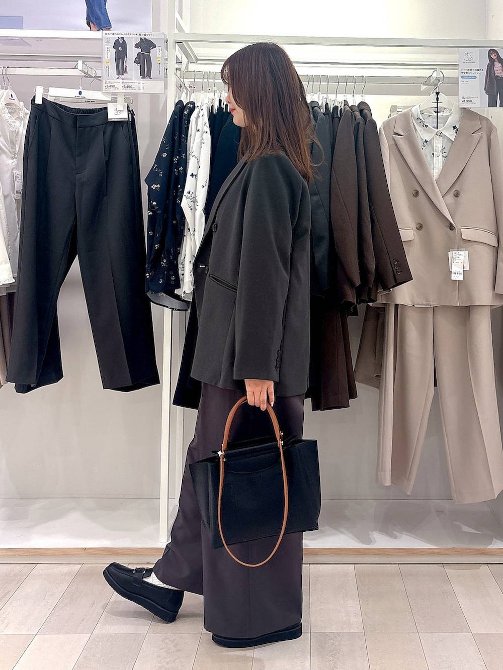 ブラック系のローファー、ブラック系のトートバッグ、グレー系のセットアップを着用したレディースの冬コーディネートの2枚目の写真