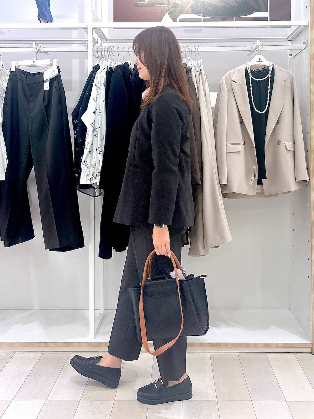 ブラック系のローファー、ブラック系のトートバッグ、グレー系のその他パンツを着用したレディースの冬コーディネートの2枚目の写真