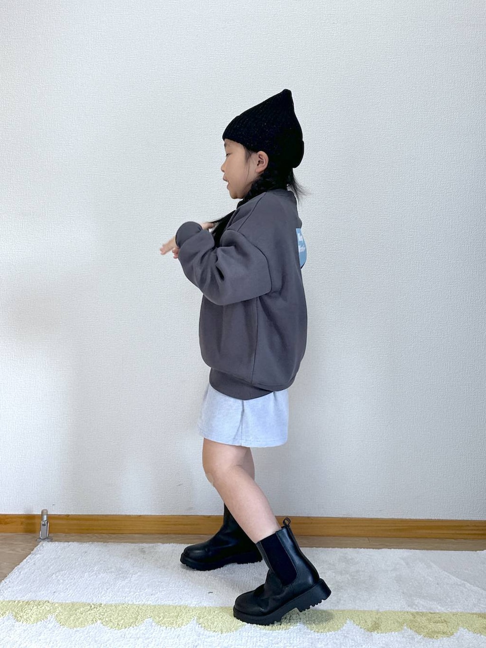 ブラック系のブーツ、ブルー系のその他パンツ、ブラック系のニットキャップ/ビーニーを着用したキッズの秋コーディネートの3枚目の写真