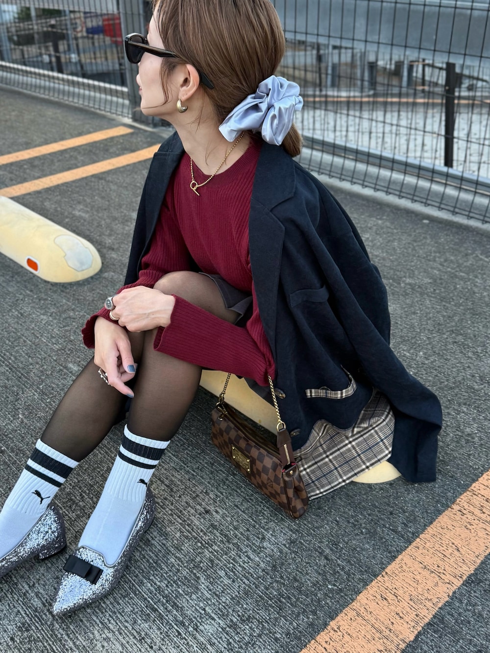 シルバー系のパンプス、レッド系のニット/セーター、ブルー系のテーラードジャケットを着用したレディースの秋コーディネートの2枚目の写真