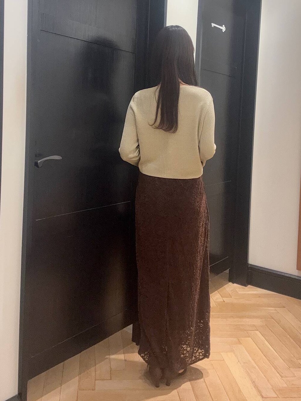 ゴールド系のカーディガン/ボレロ、ブラウン系のスカート、ブラック系のショルダーバッグを着用したレディースの夏コーディネートの3枚目の写真