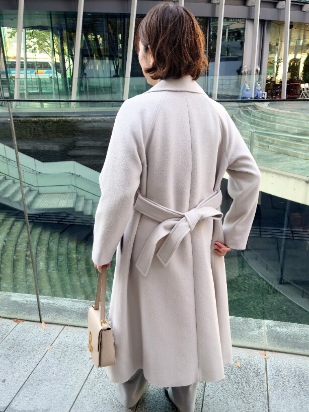 ベージュ系のその他アウター、グレー系のニット/セーター、グレー系のその他パンツを着用したレディースの冬コーディネートの5枚目の写真