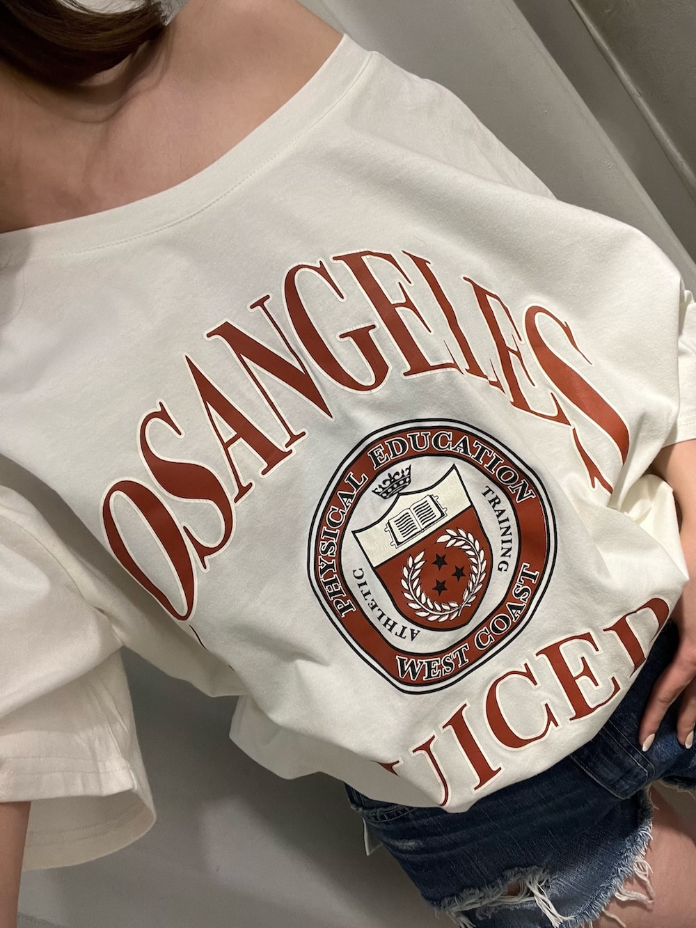 ホワイト系のブーツ、ホワイト系のTシャツ/カットソー、ブルー系のデニムパンツを着用したレディースの春コーディネートの4枚目の写真