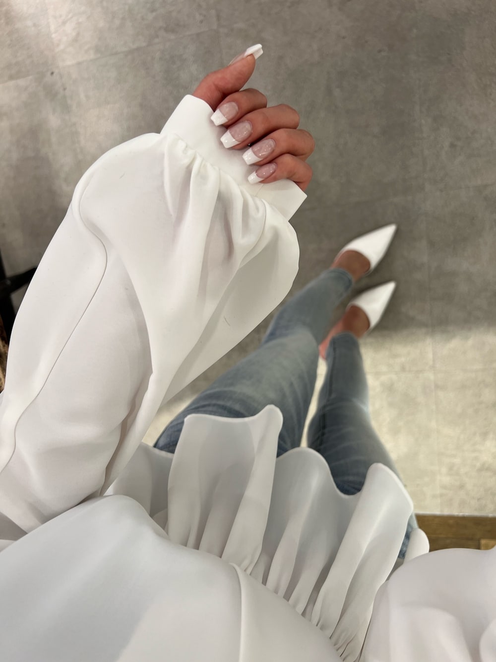 ホワイト系のシャツ/ブラウス、ブラック系のキャミソール、ブルー系のデニムパンツを着用したレディースの冬コーディネートの3枚目の写真