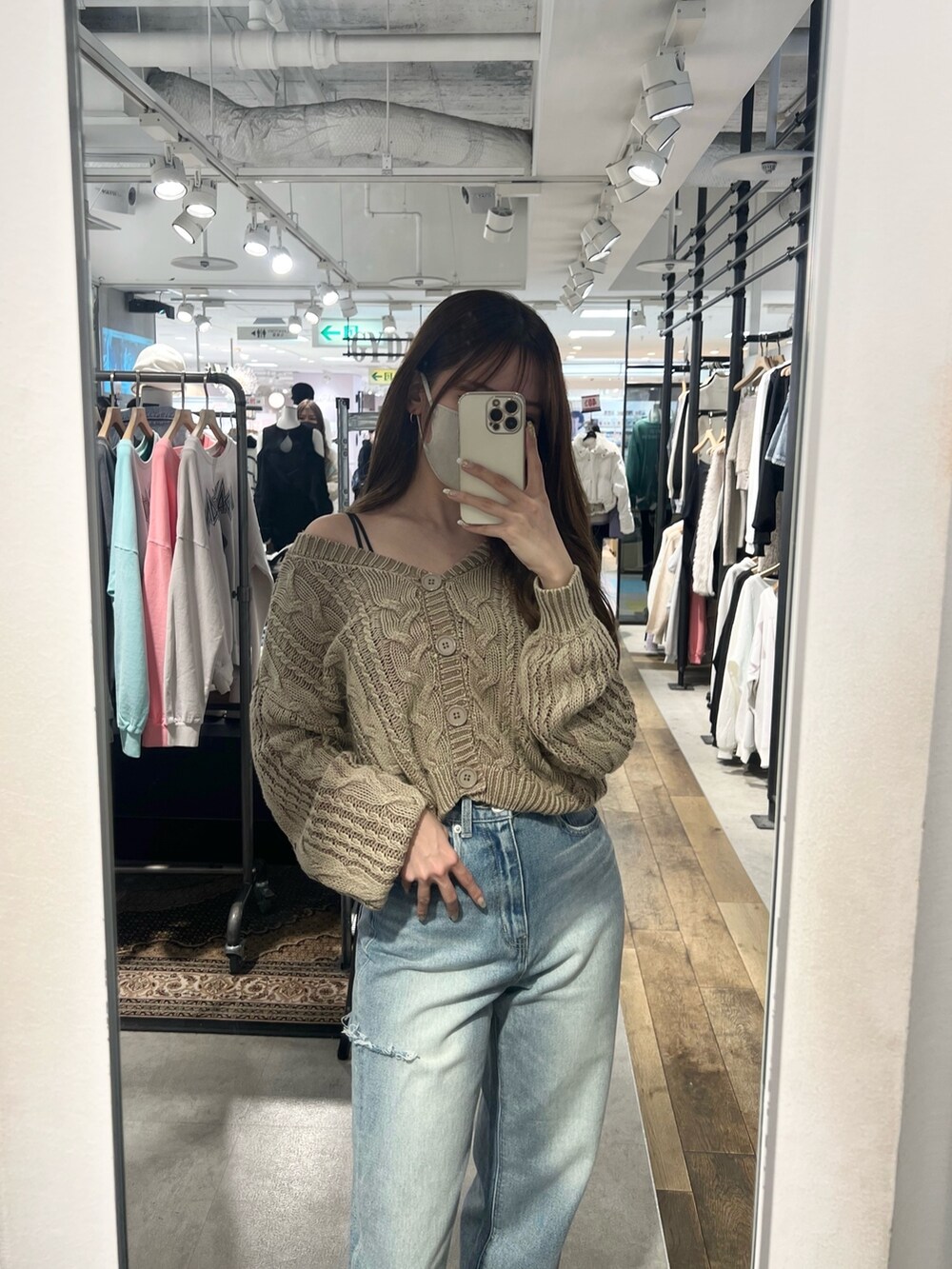 ブルー系のニット/セーター、ホワイト系のキャミソール、ブルー系のデニムパンツを着用したレディースの冬コーディネートの2枚目の写真