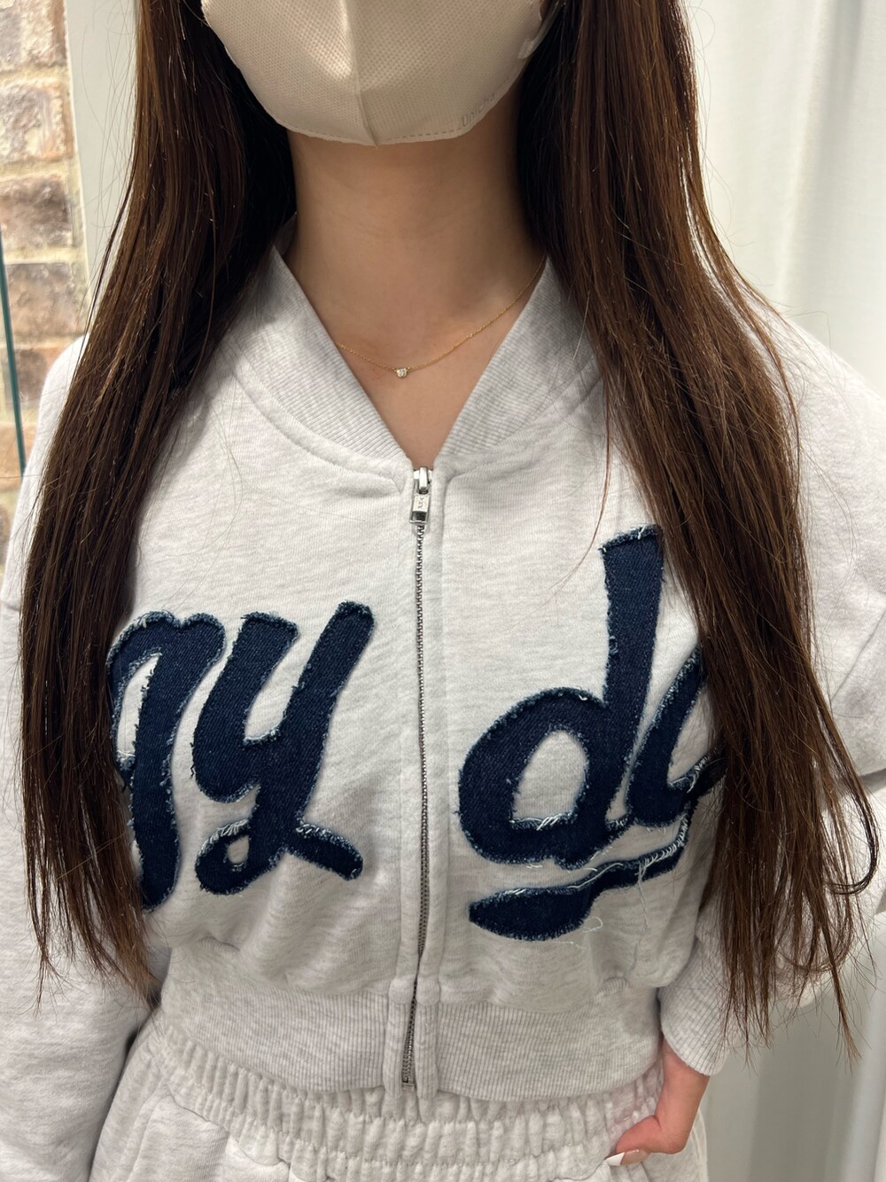 グレー系のスウェット、グレー系のスウェットパンツ、ブラック系のパンプスを着用したレディースの冬コーディネートの4枚目の写真