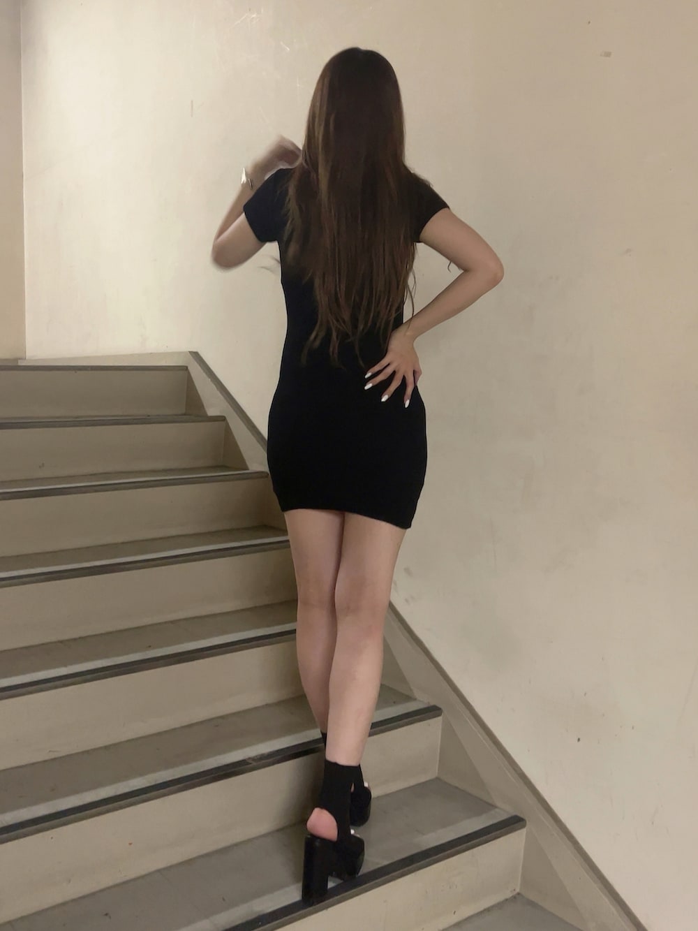 ブラック系のワンピース、ブラック系のブーツを着用したレディースの夏コーディネートの2枚目の写真