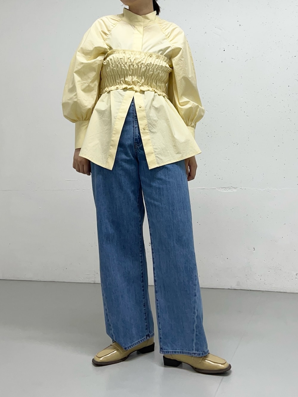 ブルー系のデニムパンツ、イエロー系のシャツ/ブラウスを着用したレディースの冬コーディネートの3枚目の写真