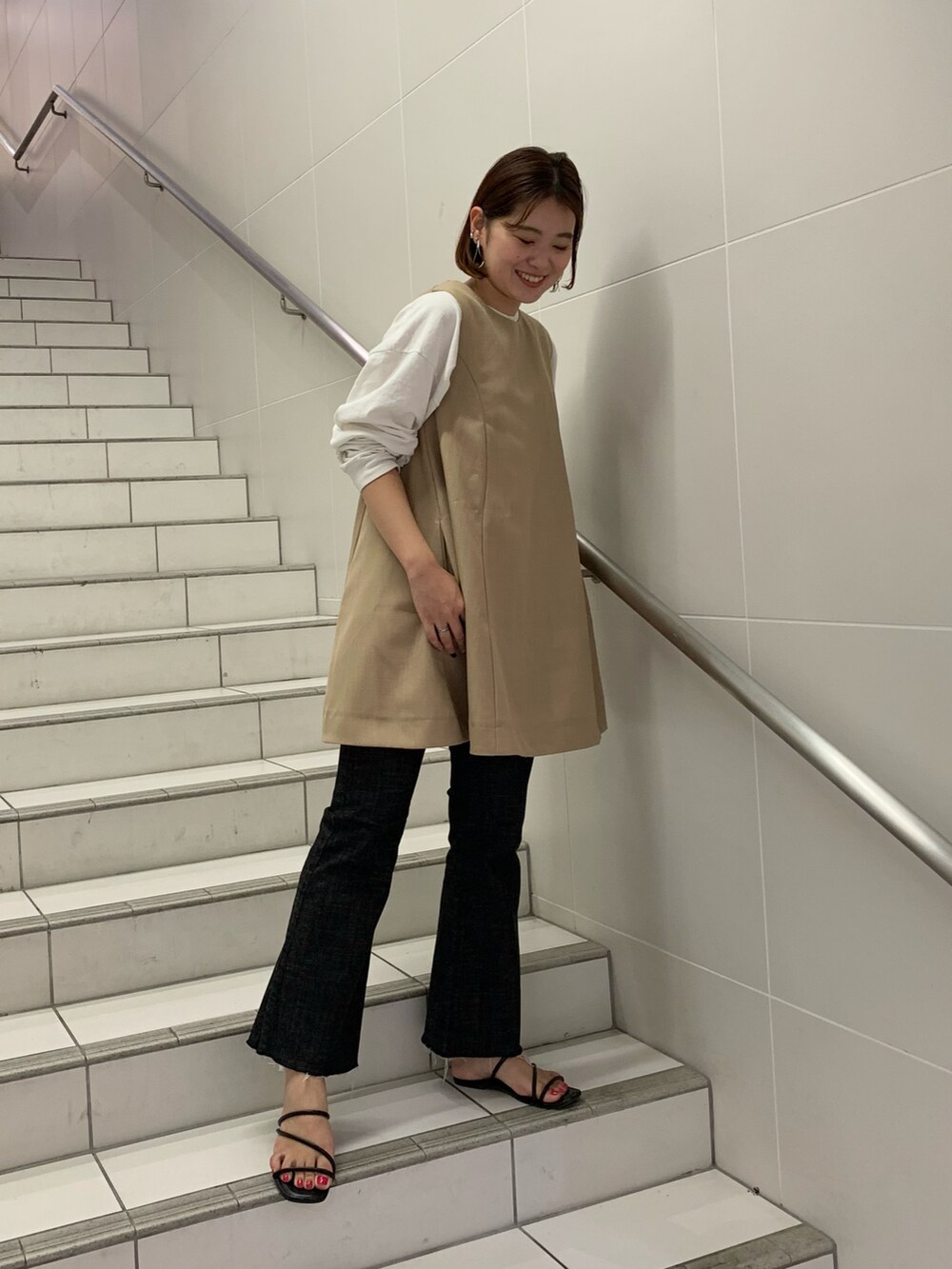 ブラック系のパンツ、ベージュ系のワンピース/ドレス、グリーン系のトートバッグを着用したレディースの夏コーディネートの4枚目の写真