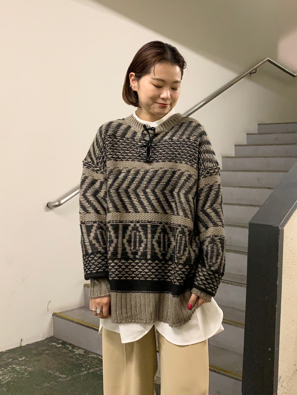 ホワイト系のスニーカー、ベージュ系のパンツ、ブラウン系のニット/セーターを着用したレディースの冬コーディネートの4枚目の写真