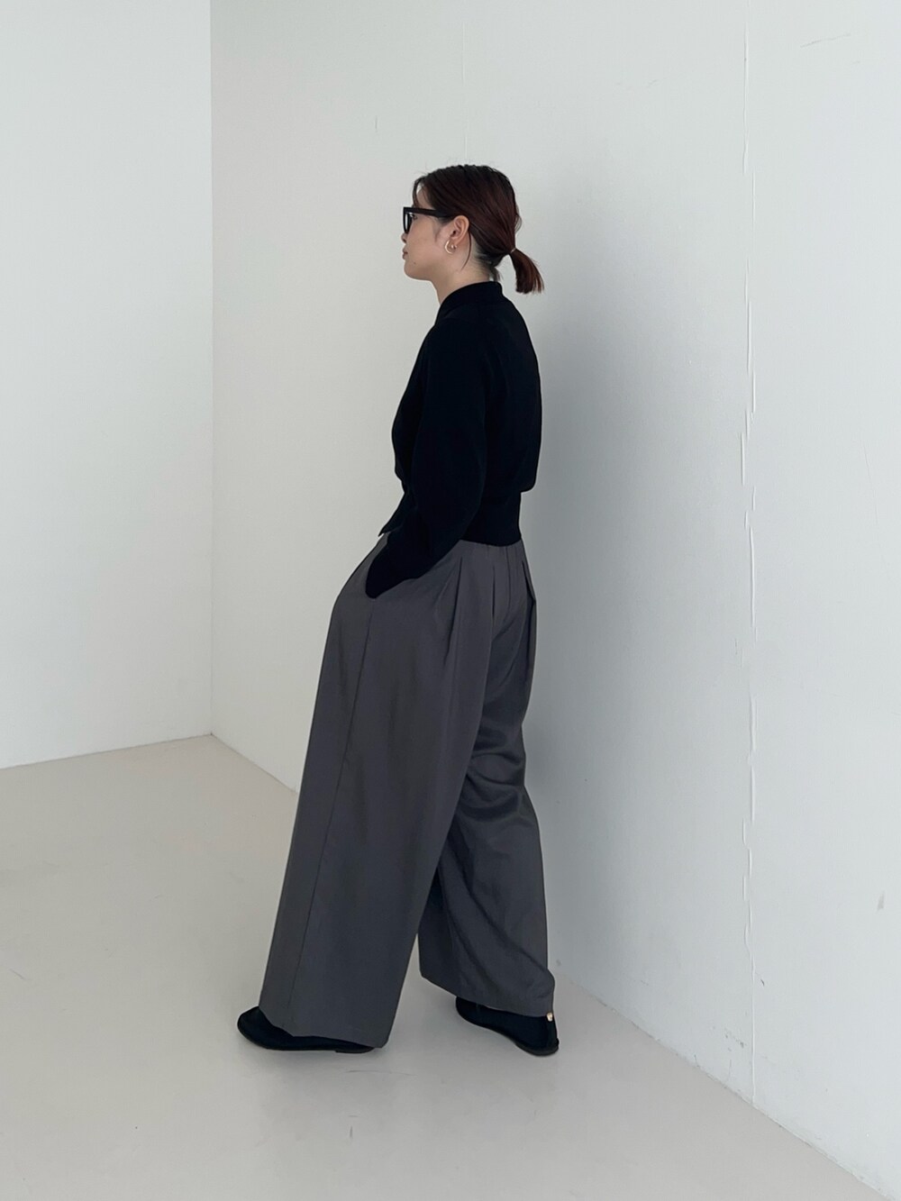 グレー系のその他パンツ、ブラック系のカーディガン/ボレロ、ブラック系のハンドバッグを着用したレディースの秋コーディネートの3枚目の写真