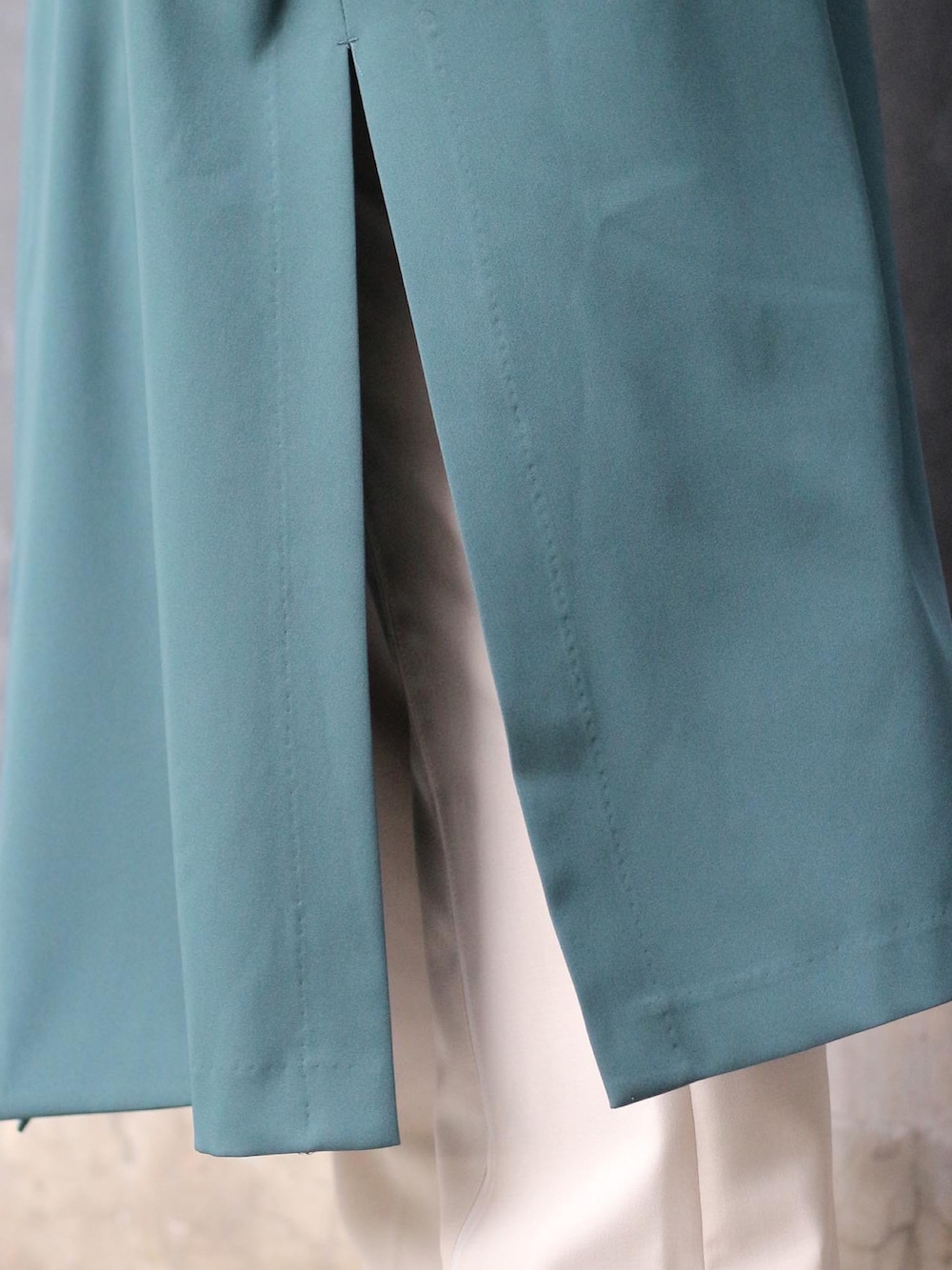 グリーン系のテーラードジャケット、ブラック系のTシャツ/カットソー、ベージュ系のスラックスを着用したレディースの春コーディネートの5枚目の写真