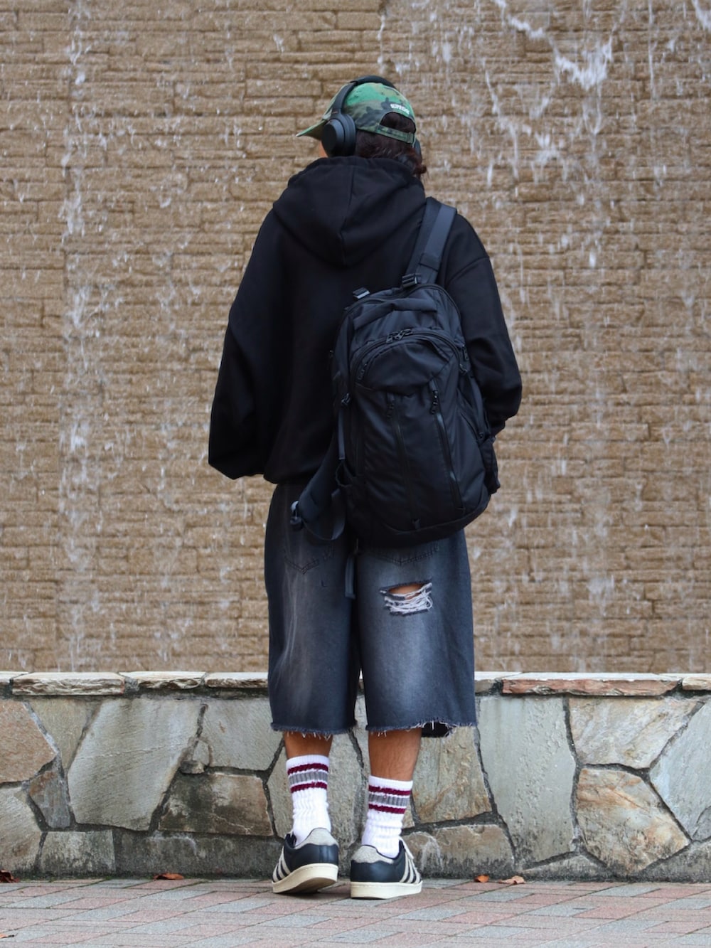 ブラック系のパーカー、ブラック系のデニムパンツを着用したメンズの秋コーディネートの4枚目の写真