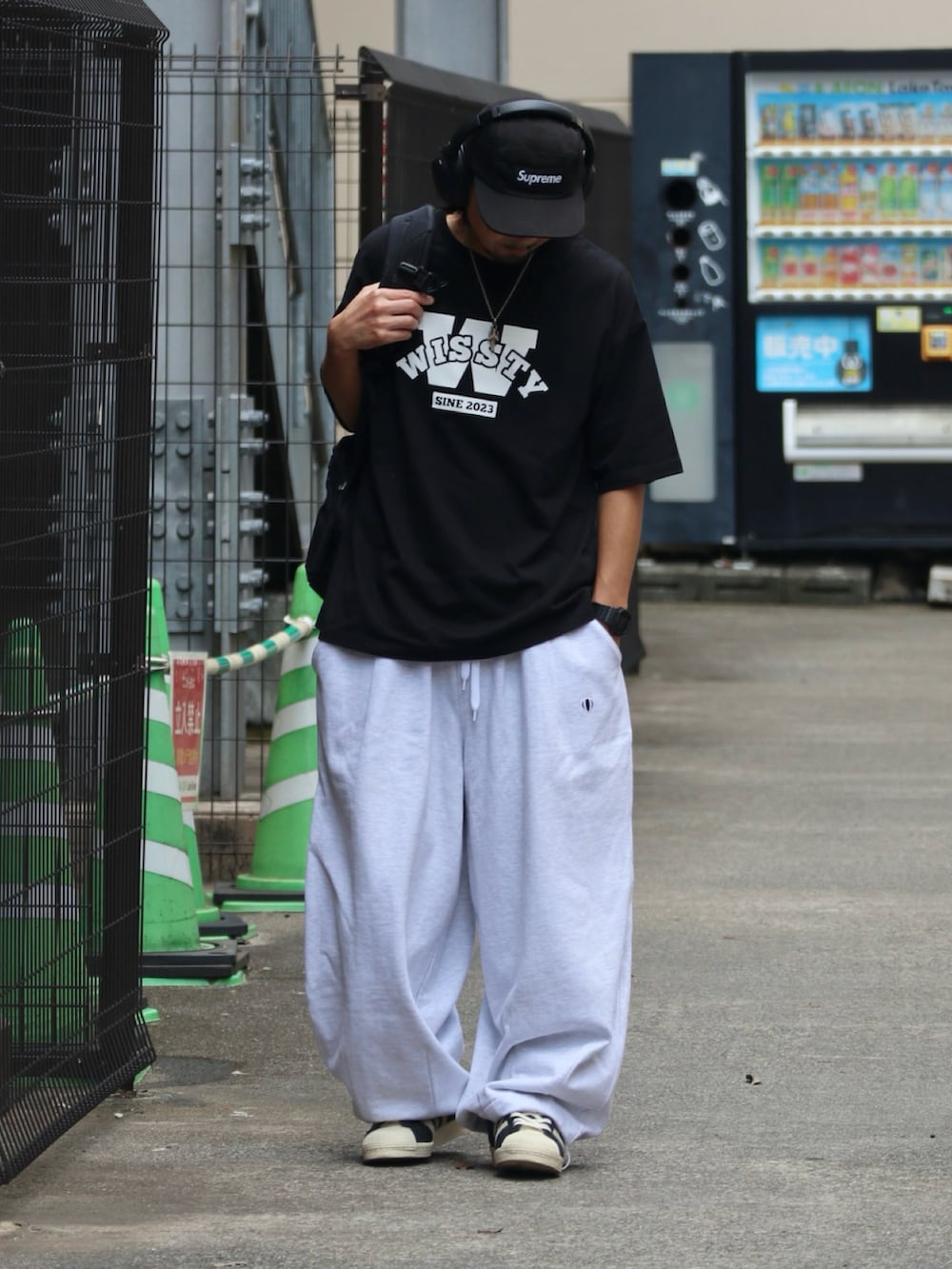 ブラック系のTシャツ/カットソー、ブラック系のスニーカーを着用したメンズの夏コーディネートの2枚目の写真