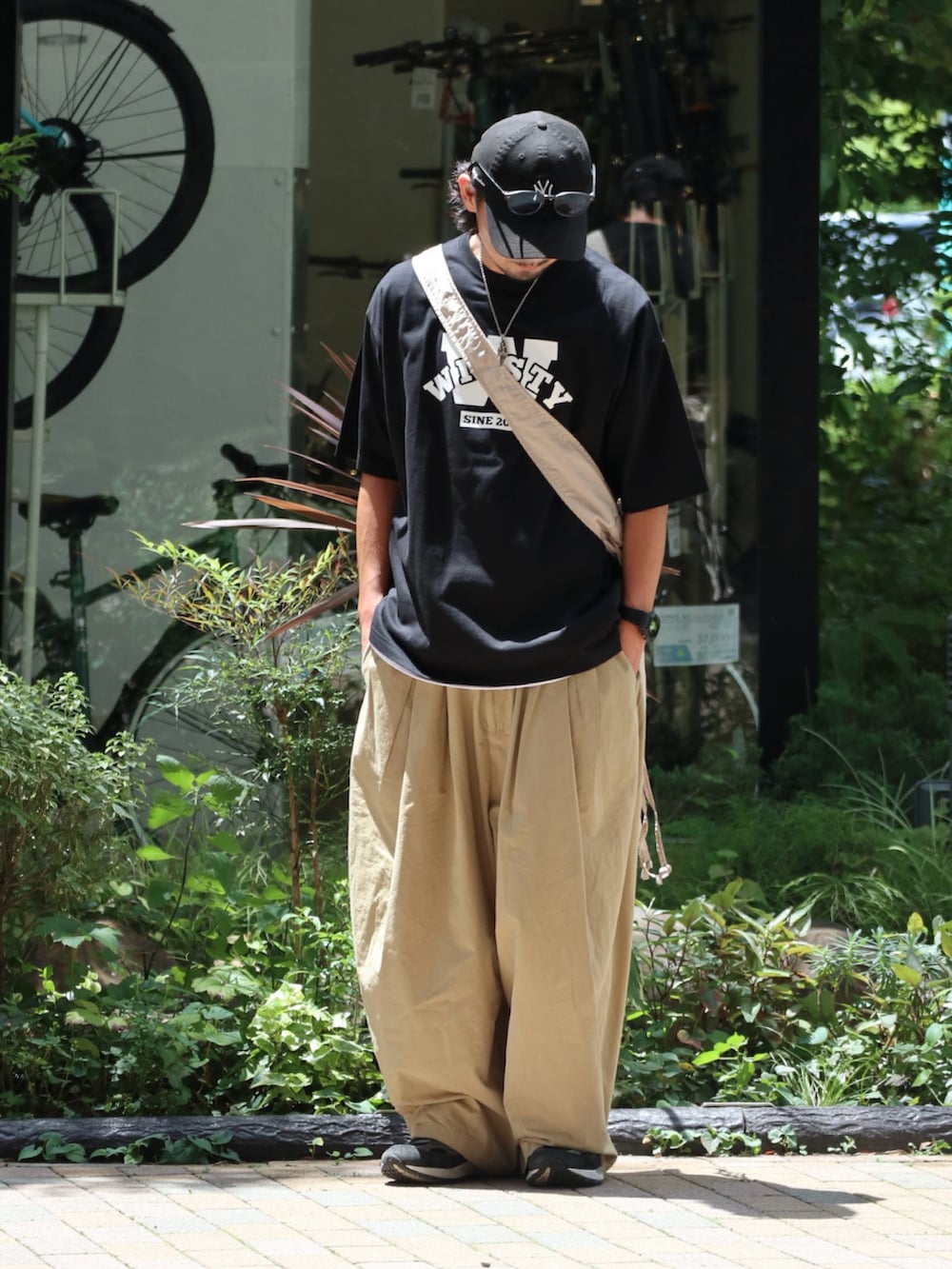 ブラック系のTシャツ/カットソーを着用したメンズの夏コーディネートの2枚目の写真