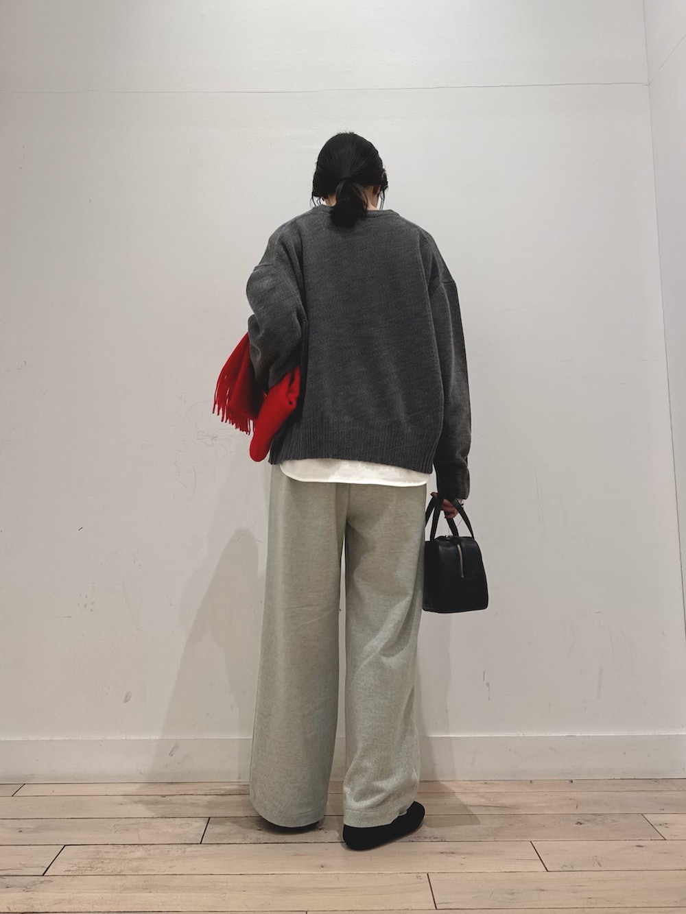 グレー系のニット/セーター、ホワイト系のTシャツ/カットソー、グレー系のその他パンツを着用したレディースの秋コーディネートの3枚目の写真