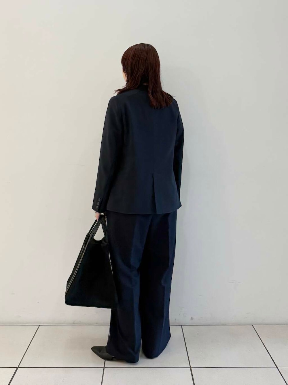 ブルー系のノーカラージャケット、ブルー系のサロペット/オーバーオール、グレー系のニット/セーターを着用したレディースの春コーディネートの6枚目の写真